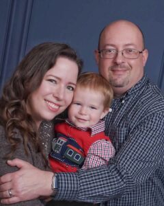 Family of three with wife on left, little boy in the middle, and husband on the right.